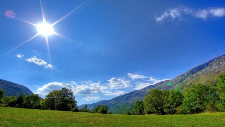 Vibrant Daylight Over Mountainous Terrain wallpaper