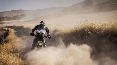 Thrilling Off-Road Motorcycle Adventure in Dusty Terrain wallpaper