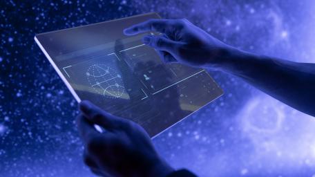 Futuristic Tablet Interaction in Outer Space Scene wallpaper