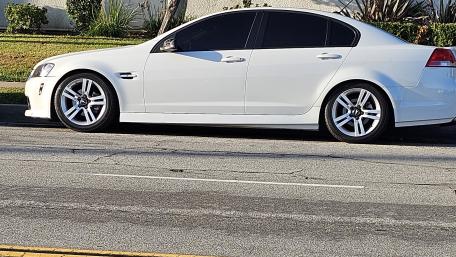 Sleek White Car on City Street wallpaper