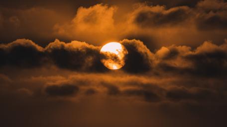 Sun shrouded by clouds wallpaper