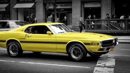 Classic Yellow Ford Mustang in Urban Setting wallpaper