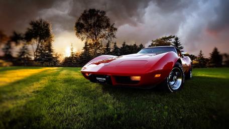 Classic Red Corvette in Twilight Setting wallpaper