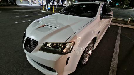 Sleek White Car in Dusk Lighting wallpaper