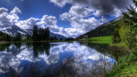 Peaceful Lake Reflection Amid Majestic Landscapes wallpaper