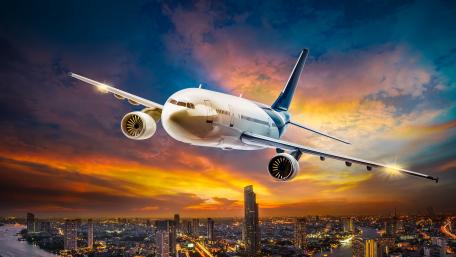 Sunset Flight Over Vibrant Cityscape wallpaper