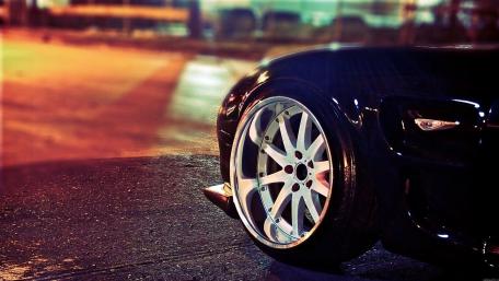 Sleek Car Under City Lights wallpaper
