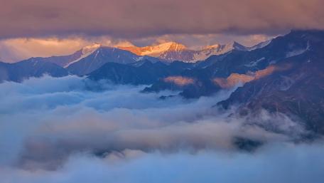 Majestic Peaks Beneath Endless Clouds wallpaper