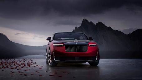 Majestic Red Sedan Amidst Mountain Serenity wallpaper