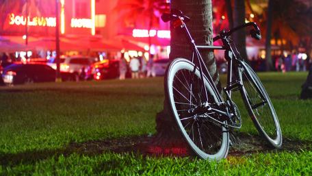 Nighttime City Bicycle Parked by a Tree wallpaper