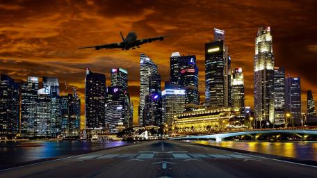 Twilight Flight Over Urban Majesty wallpaper