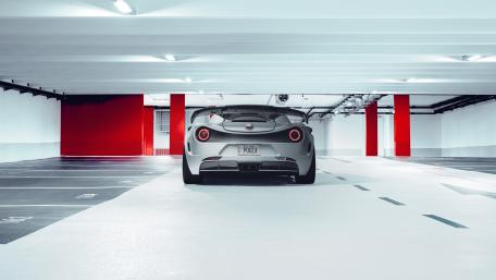 Sleek Alfa Romeo Sports Car in Futuristic Parking Garage wallpaper