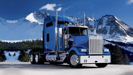 Majestic Kenworth Truck Against Snowy Mountain Backdrop wallpaper