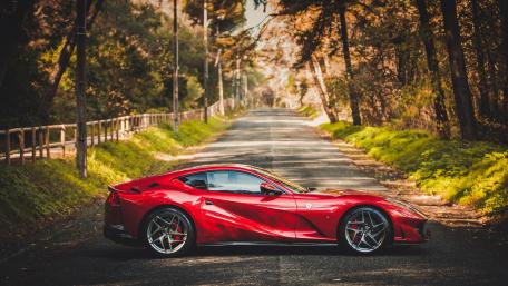 Red Ferrari 812 Superfast on Forest Road wallpaper