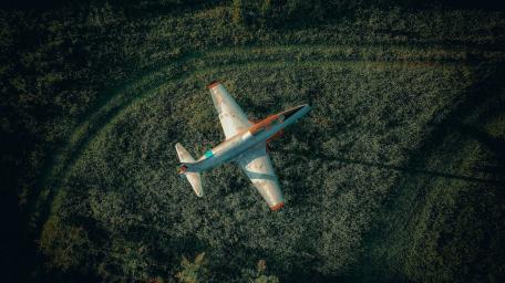 Aerial View of Aircraft Over Verdant Landscape wallpaper