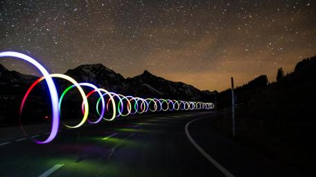 Starry Night Road Illuminated by Light Trails wallpaper