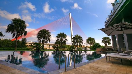 Serene Poolside Retreat Under Azure Skies wallpaper
