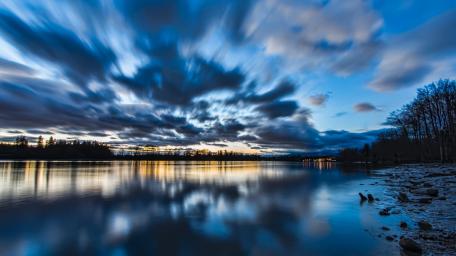 Sweeping Skies Over Tranquil Waters wallpaper