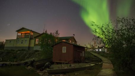 Aurora Serenade Over Countryside Retreat wallpaper