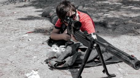 Focused Youth with Gun on Ground wallpaper