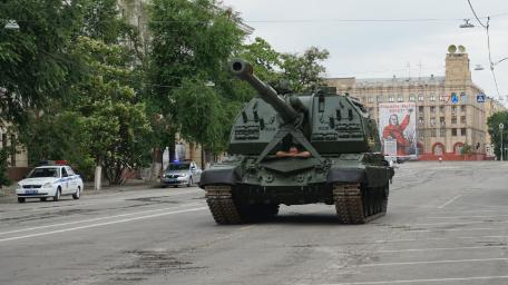 Powerful Tank on Urban Street Scene wallpaper