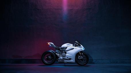 Sleek Motorcycle Under Neon Glow wallpaper