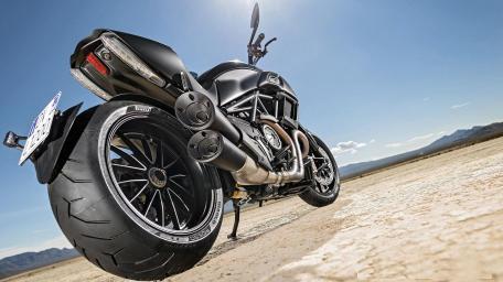 Rugged Motorcycle Dominating the Desert Landscape wallpaper