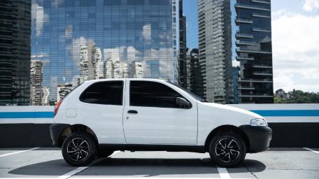 Sleek White Car Against Urban Skyline Reflection wallpaper