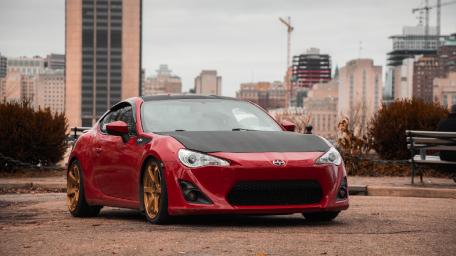 Sleek Red Sports Car in Urban Setting wallpaper
