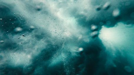 Dynamic Turquoise Waves Embracing the Deep Sea Energy wallpaper