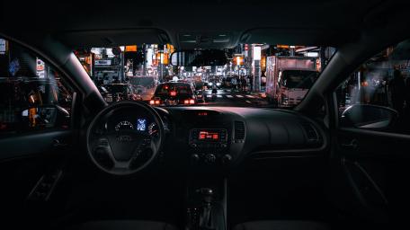 Urban Night Drive with Steering Wheel Focus wallpaper