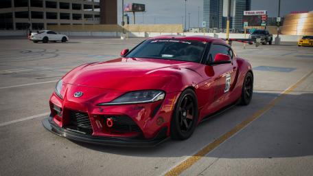 Sleek Red Sports Car in Urban Setting wallpaper