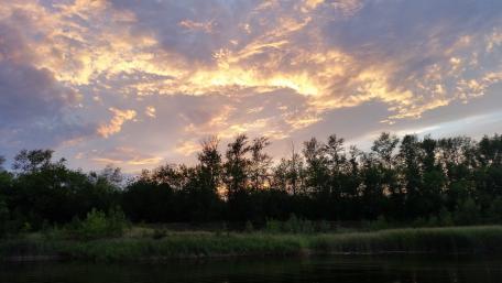 Serene Sunset Over Tranquil Riverbank wallpaper