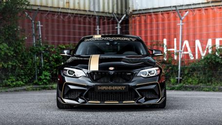 Sleek BMW M2 in Bold Black and Gold Design wallpaper