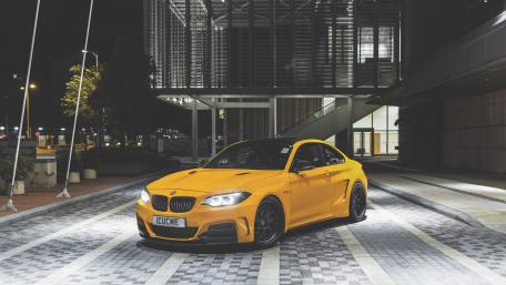 Vibrant Yellow BMW at Nighttime Urban Scene wallpaper