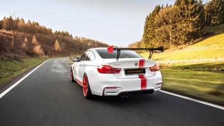 Dynamic BMW M4 on a Scenic Roadway wallpaper