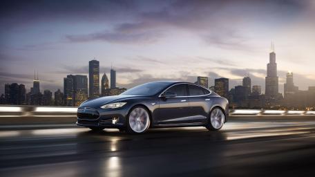 Sleek Tesla on a City Skyline Drive wallpaper