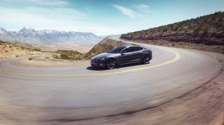 Sleek Tesla on a Serpentine Mountain Road wallpaper