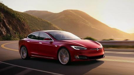Sleek Tesla Model S on a Scenic Roadside Drive wallpaper