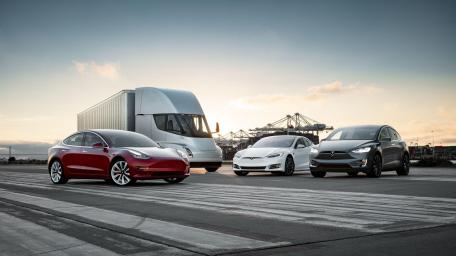 Tesla Electric Vehicles in a Modern Landscape wallpaper