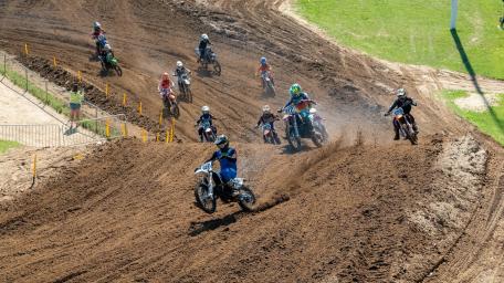 Thrilling Motocross Action on Dirt Track wallpaper