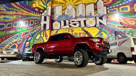 Vibrant Houston Mural with Red Pickup Truck wallpaper