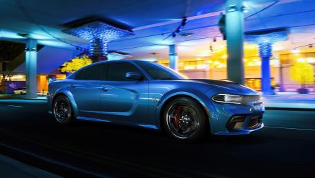 Dynamic Dodge Challenger in Vibrant Night Setting wallpaper
