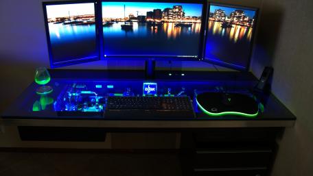 Sleek Nighttime Desk Setup with Cityscape View wallpaper
