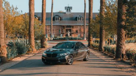 Elegant BMW in Scenic Driveway Setting wallpaper