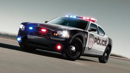 Speeding Police Interceptor in Action wallpaper
