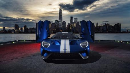 Futuristic Supercar Against City Skyline wallpaper