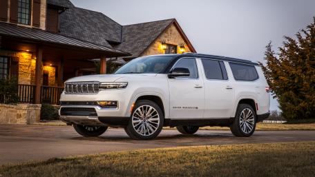 Elegant SUV Before Majestic House wallpaper