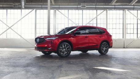 Sleek Red SUV in Industrial Setting wallpaper