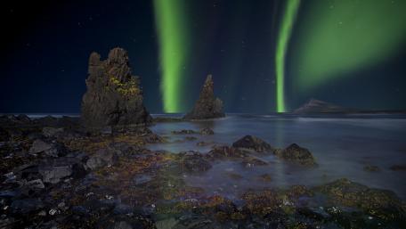 Mystic Aurora Over Rugged Shoreline of the Trékyllisvík bay wallpaper
